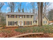 Charming two-story home with a well-maintained lawn, mature trees, and a classic facade at 2225 Mountain Creek Dr, Tucker, GA 30087