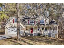 Two-story house with a wraparound porch and attached garage at 4684 Pine Dr, Loganville, GA 30052