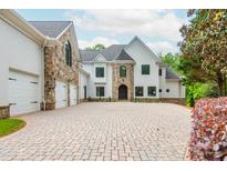 Luxury home with stone accents and a large driveway at 500 Covington Cv, Alpharetta, GA 30022