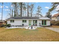 Charming ranch home with white brick exterior and green accents at 399 Patricia Sw Ave, Marietta, GA 30060