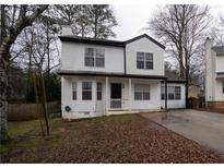 Two-story house with white siding, driveway, and mature trees at 592 Waynes Ct, Atlanta, GA 30354
