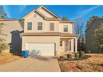 Two-story house with beige siding, white garage door, and landscaping at 157 Parkview Place Dr, Mcdonough, GA 30253