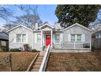 Gray renovated house with red door, white trim, and steps leading to a porch at 1320 Hosea L Williams Ne Dr, Atlanta, GA 30317