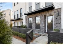 Modern brick townhome exterior with private gated entry and landscaping at 860 Constellation Dr, Decatur, GA 30033