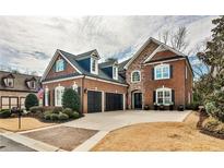 Beautiful brick two-story home with a manicured lawn and two-car garage, complete with black shutters and dark blue roof at 1250 Atherton Park, Roswell, GA 30076