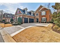 Beautiful two-story brick home with well-maintained landscaping, a spacious driveway, and an attached two-car garage at 1250 Atherton Park, Roswell, GA 30076
