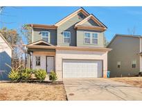 Two-story house with gray siding, white brick, and a two-car garage at 161 Parkview Place Dr, Mcdonough, GA 30253