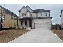 Charming two-story home with brick exterior, covered porch, and two-car garage at 5043 Baywood Ln, Woodstock, GA 30188