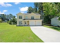 Two-story house with a two-car garage and landscaped lawn at 1215 Brook Meadow Ct, Lawrenceville, GA 30045