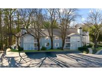Charming condo exterior featuring a light blue facade, trimmed balconies, and a well maintained parking area at 2732 Suwanee Se Way, Marietta, GA 30067