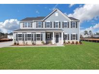 Two story house with gray siding, white trim, and a grassy lawn at 328 Meuse Ln, Locust Grove, GA 30248
