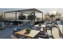 Expansive rooftop deck with pergola, outdoor seating, pool and dining area offers the perfect place to relax and entertain at 318 Sandy Springs Cir # 260, Sandy Springs, GA 30328