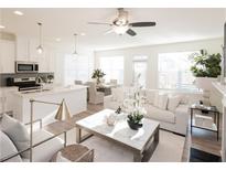 Bright and airy living room featuring modern decor, stylish furniture, and a ceiling fan at 1621 Aiden Way # 57, Conyers, GA 30013