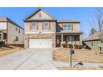 Two-story house with stone accents and a large driveway at 561 Greyhound Ct, Union City, GA 30291