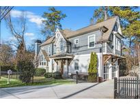 Gray-toned two-story house with a fenced yard and attached garage at 3405 Roswell Ne Rd, Atlanta, GA 30305