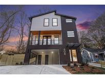 Modern two-story home with dark brown and white siding, attached garage, and landscaping at 608 S Evelyn Nw Pl, Atlanta, GA 30318