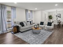 Cozy living room featuring hardwood floors, ample natural light, and stylish furniture at 3308 Wildwood Sw Dr, Marietta, GA 30060