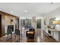Inviting living room features a stone fireplace, hardwood floors, modern furniture, and an open-concept layout at 4676 Vinings Central Se Run # 104, Atlanta, GA 30339