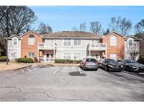 Brick front exterior of a two-story townhome building with parking at 4008 Orchard Hill Ter, Stone Mountain, GA 30083