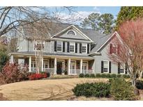 Two-story home with gray siding and wrap-around porch at 620 Regency Forest Ct, Atlanta, GA 30342