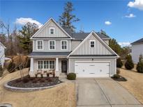 Two-story house with gray siding, white trim, and a landscaped yard at 6285 Vista Crossing Way, Cumming, GA 30028