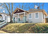 Charming craftsman bungalow with a covered porch and well-manicured lawn at 135 Adair Se Ave, Atlanta, GA 30315