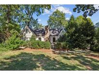 Charming home featuring a stone chimney and meticulously maintained landscaping at 250 Lakeview Ne Ave, Atlanta, GA 30305