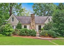 Charming home featuring a stone chimney and mature landscaping at 250 Lakeview Ne Ave, Atlanta, GA 30305