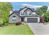 Two-story house with stone accents, landscaped yard, and a two-car garage at 4503 Mulberry Fields Ln, Auburn, GA 30011