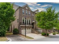 Brick front exterior of 3 story townhome with attached 2 car garage at 2381 Willington Shoals Pl # 21, Smyrna, GA 30080