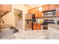 Modern kitchen with stainless steel appliances and granite countertops at 1250 Parkwood Cir # 2312, Atlanta, GA 30339