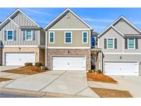 Charming townhome with brick and siding exterior and attached garage at 7492 Knoll Hollow Rd, Lithonia, GA 30058