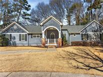 Charming single-story home with gray siding, well-manicured lawn, and inviting front porch at 889 City Park Se Dr, Atlanta, GA 30312