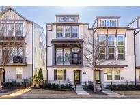 Beautiful three-story townhome featuring a balcony, fenced yard, and classic architectural design at 927 Katie Kerr Dr, Decatur, GA 30030