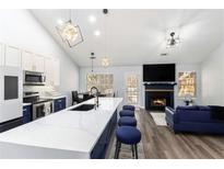 Modern kitchen with white and blue cabinets, quartz countertops, and stainless steel appliances at 4749 Brookwood Vw, Atlanta, GA 30349