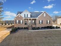 Brick house with a large front yard and attached garage at 8967 Midlothian Ct, Winston, GA 30187