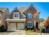 Charming two-story brick home featuring a two-car garage and manicured landscaping at 11644 Parkside Ave, Alpharetta, GA 30005