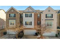 Charming townhome with a brick and siding facade and attached two-car garage at 2116 Tidal Cv, Lawrenceville, GA 30043