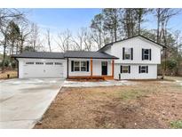Newly renovated farmhouse-style home with a charming front porch at 85 Hickory Dr, Stockbridge, GA 30281