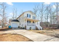 Two-story house with attached garage and porch at 45 Hunters Ridge Ct, Covington, GA 30014