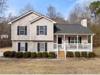 Two-story house with gray roof, beige siding, and a front porch at 2712 Sam Calvin Dr, Dacula, GA 30019