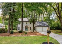 Charming two-story home featuring a lush front yard, and a two car garage at 2189 Wood Glen Se Ln, Marietta, GA 30067