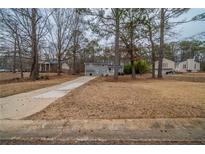 Traditional two-story home featuring a long drive and mature trees in a suburban neighborhood at 6520 Chickasaw Dr, Douglasville, GA 30135