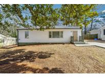 White ranch home with a metal roof, and small front yard at 1770 Lee St, Decatur, GA 30035