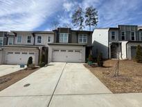 New construction townhomes with light brick, light grey paint, and two car garages at 2113 Garden Pl, Atlanta, GA 30316