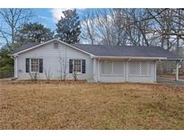 Ranch style home with carport and mature trees at 280 Belmont Farms Dr, Ellenwood, GA 30294