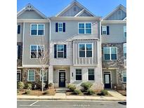 Attractive townhome with a blend of grey siding and white brick, enhancing curb appeal and architectural detail at 1716 Prelude, Marietta, GA 30067