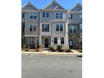 Two-story townhome with neutral siding and landscaping at 1716 Prelude, Marietta, GA 30067