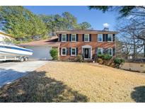 Brick house with a two-car garage and boat at 1956 Spencer Oaks Ln, Lithonia, GA 30058
