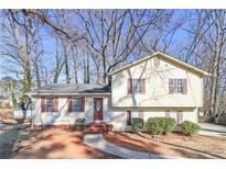 Two-story house with beige siding, brown shutters, and a landscaped yard at 52 Landmark Sw Ln, Marietta, GA 30060